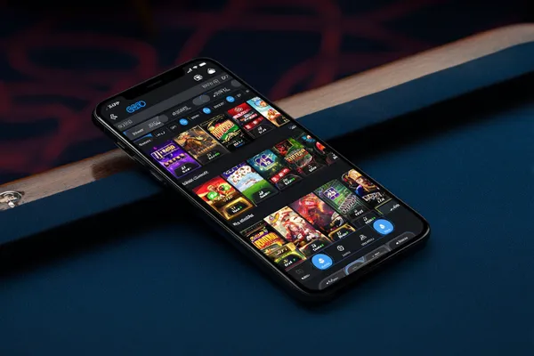 A young woman relaxing with her phone while dynamic casino elements float around her, illustrating the smooth mobile experience offered by the BA999A app.