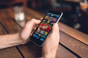 A cheerful woman in traditional clothing using her smartphone during a festive moment, showing how easily the BA999A app fits into everyday life.