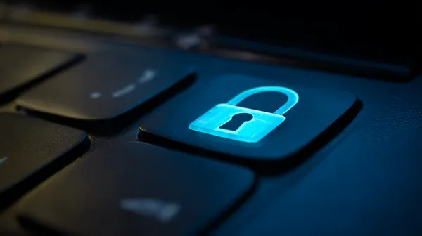A laptop glowing with a bright login prompt in a minimalistic setup, symbolizing the protected access system at BA999A.